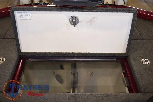 Slide: The Image of 2017 Ranger Z521C boat storage compartment with open lid, featuring carpeted interior. - 35