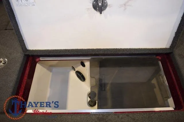 Slide: The Image of 2017 Ranger Z521C storage compartment with open lid, featuring Thayer's Marine branding. - 37