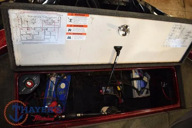 Slide: The Image of 2017 Ranger Z521C boat storage compartment with battery and wiring. - 40