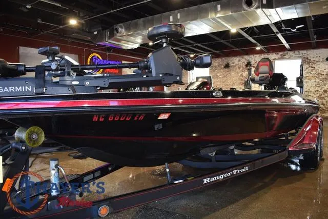 Slide: The Image of 2017 Ranger Z521C bass boat on display indoors, featuring Garmin equipment. - 5