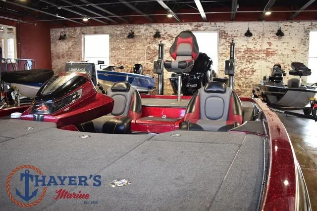 Slide: The Image of 2017 Ranger Z521C bass boat with red and black seats in showroom. - 8