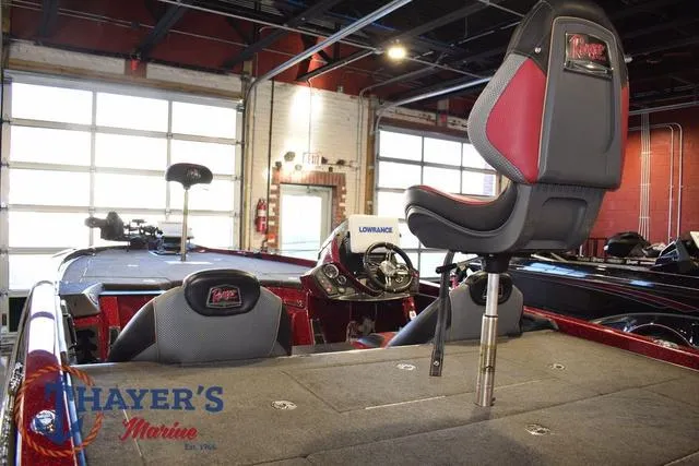 Slide: The Image of 2017 Ranger Z521C boat interior with seating and dashboard at Thayer's Marine showroom. - 9