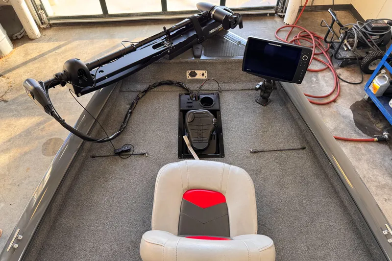 Slide: The Image of 2016 Tracker Pro Team 190 TX boat interior with fishing equipment and seating. - 2