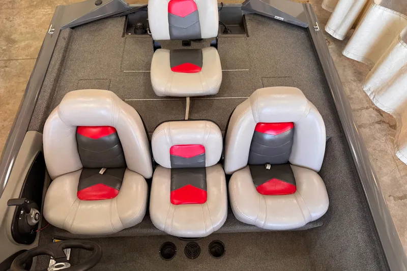 Slide: The Image of 2016 Tracker Pro Team 190 TX boat interior with gray and red seating. - 3