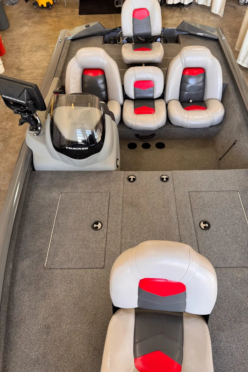Slide: The Image of 2016 Tracker Pro Team 190 TX boat interior with gray and red seating. - 4