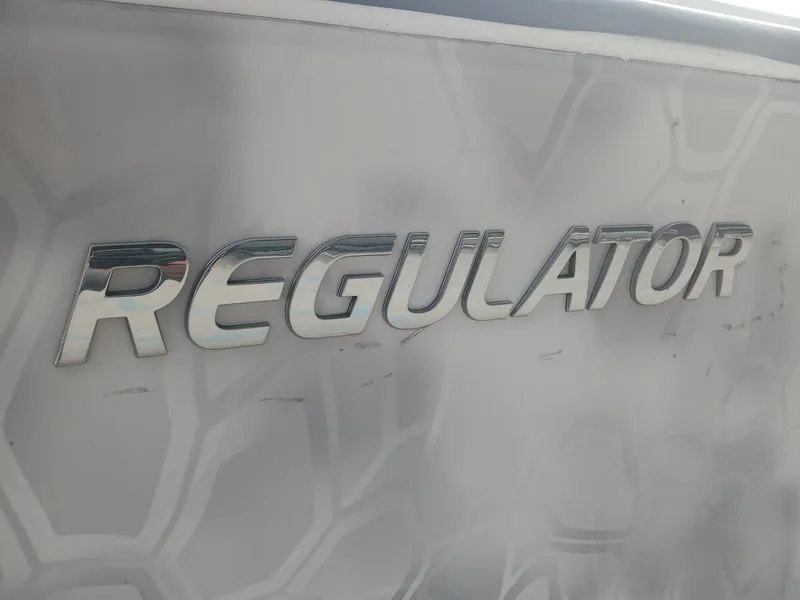 Slide: The Image of Regulator 32 boat logo on a 2001 model with textured background. - 15