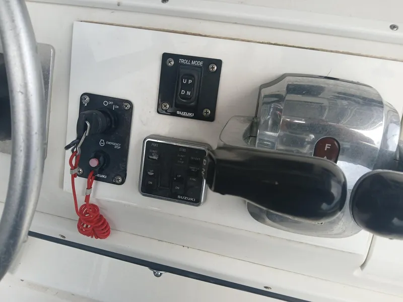 Slide: The Image of Control panel of a 2001 Regulator 32 boat with throttle and switches. - 2