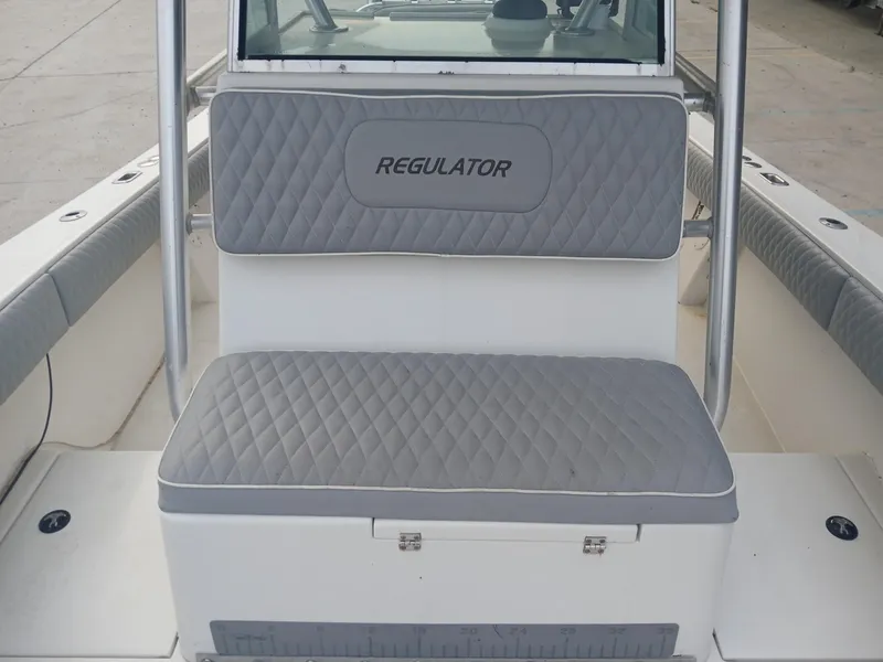 Slide: The Image of 2001 Regulator 32 boat seating with gray quilted cushions. - 4
