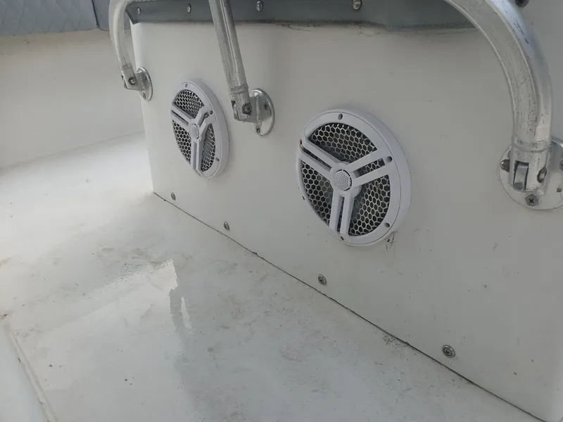 Slide: The Image of 2001 Regulator 32 boat interior with dual speakers and metal handrails. - 7