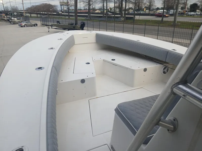 Slide: The Image of 2001 Regulator 32 boat with spacious deck and cushioned seating. - 8