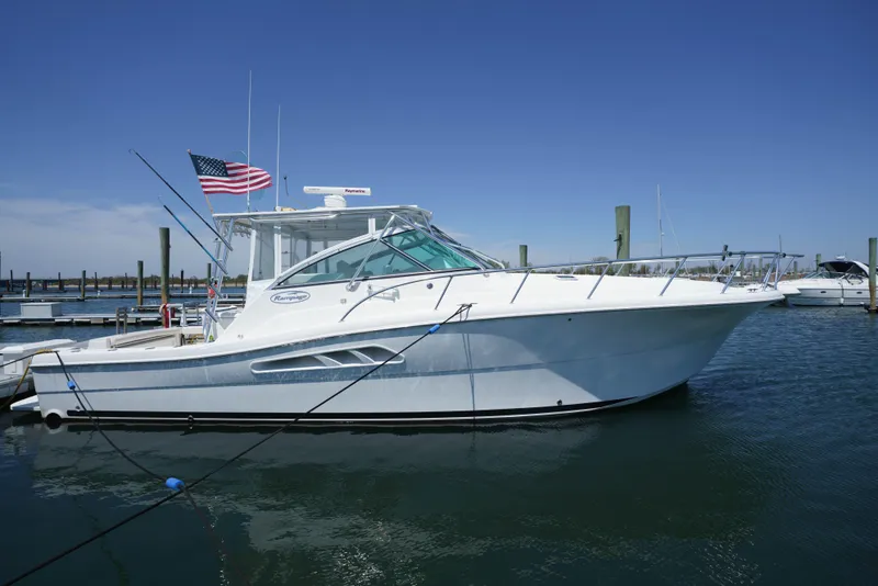 The Image of 2011 Rampage 41 Express boat docked, featuring sleek design and American flag. - 0