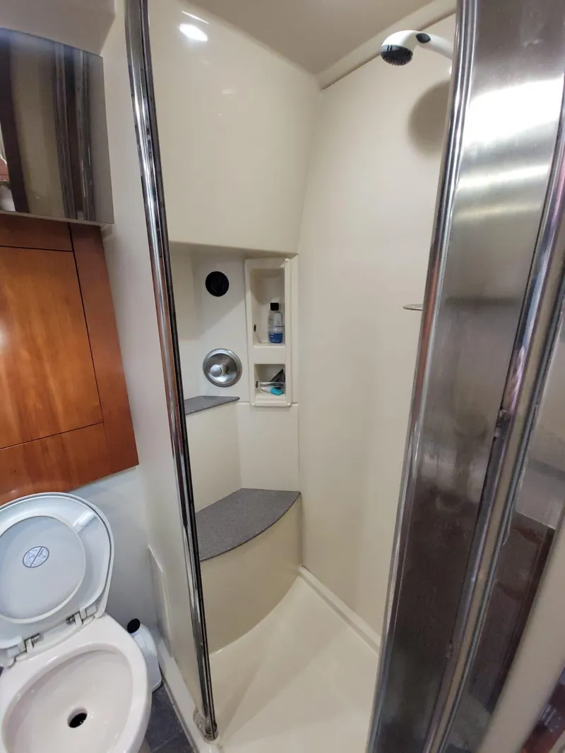Slide: The Image of 2011 Rampage 41 Express yacht bathroom with shower, toilet, and wooden cabinetry. - 12