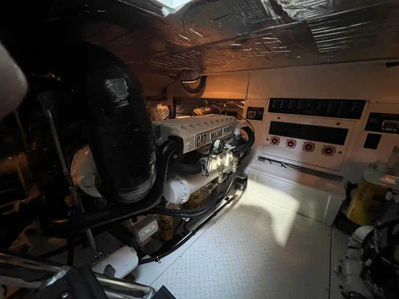 Slide: The Image of Engine room of 2011 Rampage 41 Express boat, featuring CAT marine engine. - 16