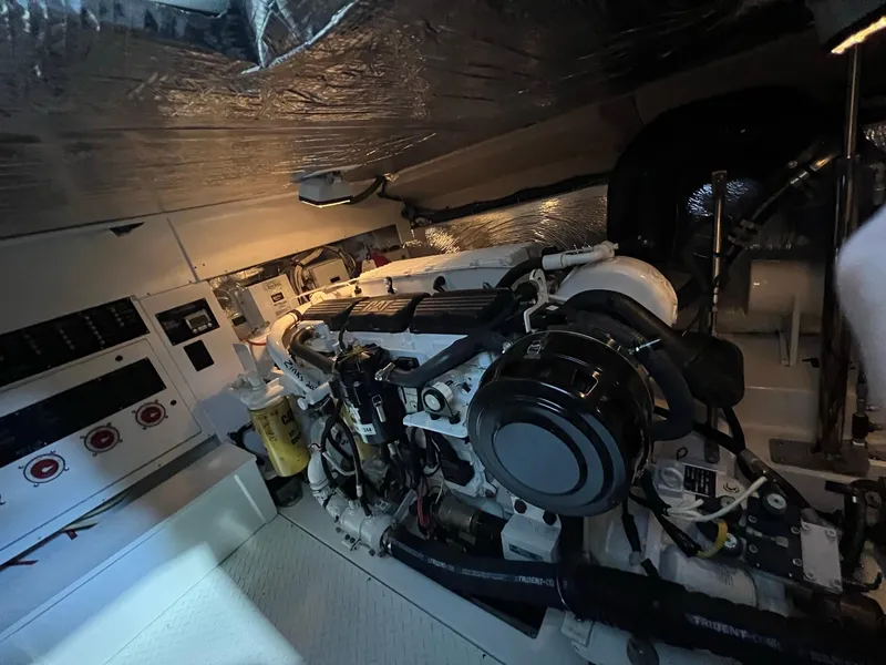 Slide: The Image of Engine room of 2011 Rampage 41 Express boat, showcasing machinery and control panels. - 18