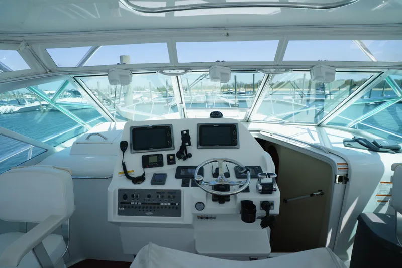 Slide: The Image of Cockpit of 2011 Rampage 41 Express yacht with navigation equipment and steering wheel. - 22