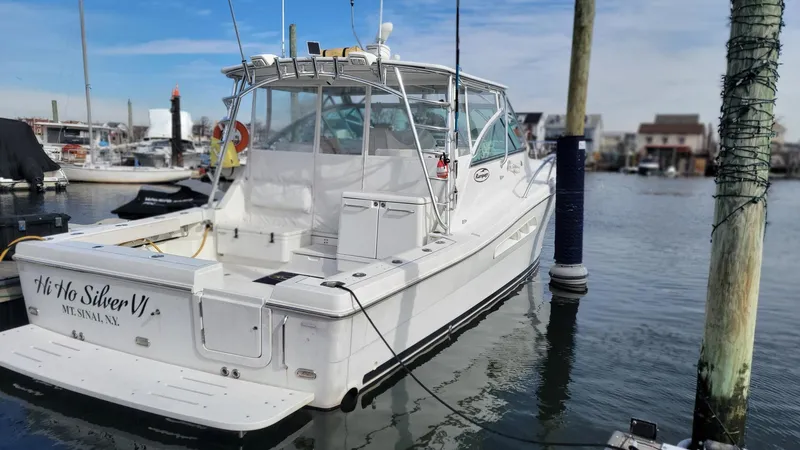 Slide: The Image of 2011 Rampage 41 Express boat docked in marina, rear view. - 4