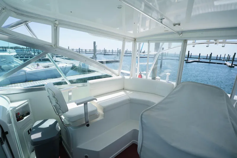 Slide: The Image of Interior of 2011 Rampage 41 Express yacht with white seating and marina view. - 5