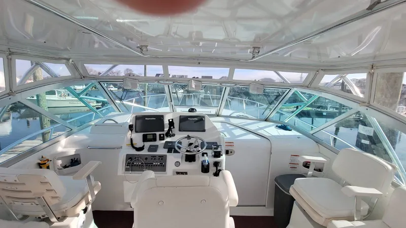 Slide: The Image of Interior view of 2011 Rampage 41 Express yacht cockpit with steering and navigation equipment. - 6