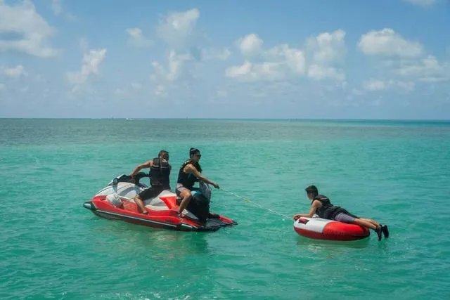 Slide: The Image of 2025 Yamaha Waverunner VX Limited towing a person on an inflatable tube in clear blue water. - 16
