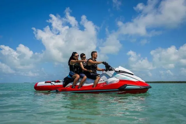 Slide: The Image of Three people riding a 2025 Yamaha Waverunner VX Limited on clear blue water. - 19
