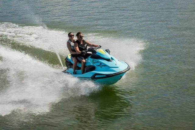 Slide: The Image of 2025 Yamaha Waverunner VX Limited HO speeding on water with two riders. - 17