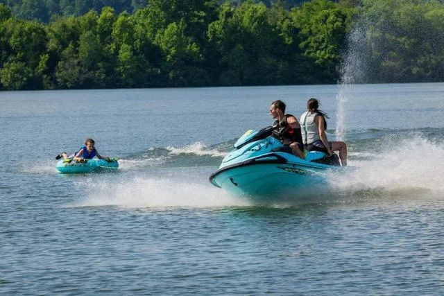 Slide: The Image of 2025 Yamaha Waverunner VX Limited HO towing a tube on a scenic lake. - 18