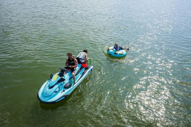 Slide: The Image of 2025 Yamaha Waverunner VX Limited HO towing a person on an inflatable tube in sunny waters. - 19