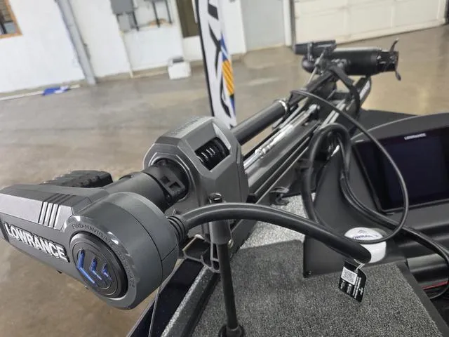 Slide: The Image of 2025 Caymas CX21 Pro boat with Lowrance equipment in a garage setting. - 15