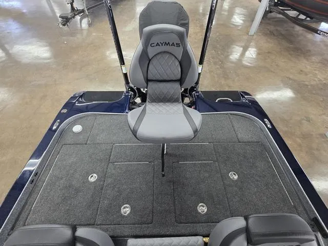 Slide: The Image of 2025 Caymas CX21 Pro boat interior with gray seating and carpeted deck. - 18