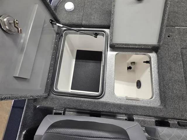 Slide: The Image of 2025 Caymas CX21 Pro boat storage compartments with open lids, showcasing interior design. - 20