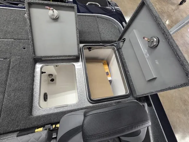 Slide: The Image of 2025 Caymas CX21 Pro boat storage compartments with open lids, showcasing interior space. - 21