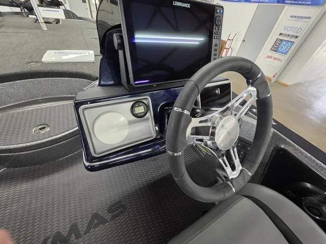 Slide: The Image of 2025 Caymas CX21 Pro boat dashboard with steering wheel and Lowrance display. - 29
