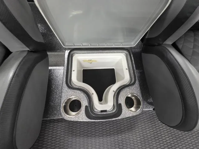 Slide: The Image of 2025 Caymas CX21 Pro boat interior with storage compartment and cup holders. - 33