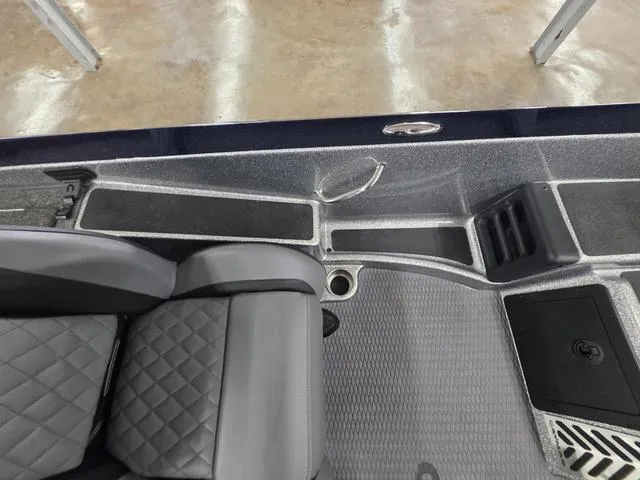 Slide: The Image of 2025 Caymas CX21 Pro boat interior with gray seating and storage compartments. - 34