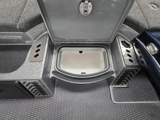 Slide: The Image of 2025 Caymas CX21 Pro boat storage compartment with open lid and textured flooring. - 36