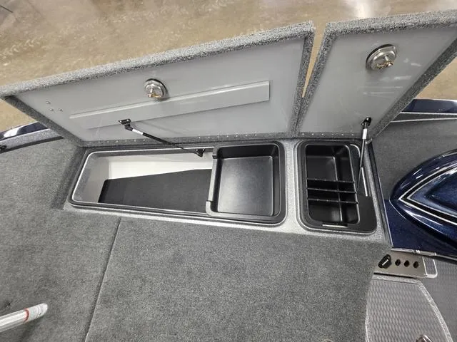 Slide: The Image of 2025 Caymas CX21 Pro boat storage compartments with open lids, showcasing organized interior space. - 37