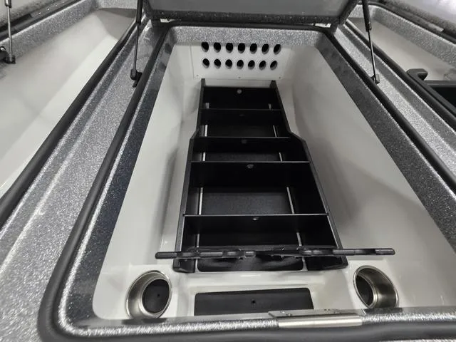 Slide: The Image of 2025 Caymas CX21 Pro boat storage compartment with organized shelving and cup holders. - 39