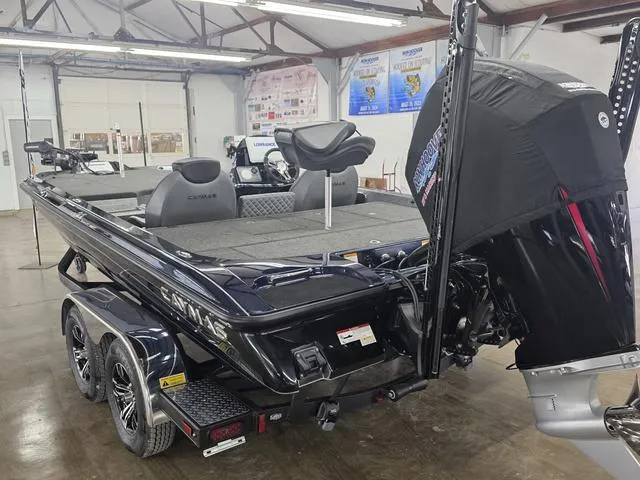 Slide: The Image of 2025 Caymas CX21 Pro boat in showroom, featuring dual seats and powerful outboard motor. - 4