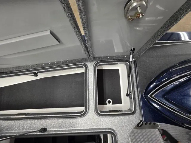 Slide: The Image of 2025 Caymas CX21 Pro boat storage compartments with open lids and sleek design. - 41