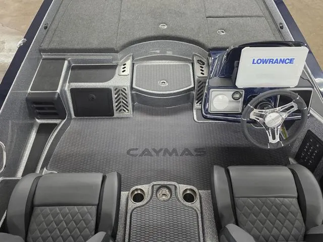 Slide: The Image of 2025 Caymas CX21 Pro boat interior with steering wheel and Lowrance electronics. - 8