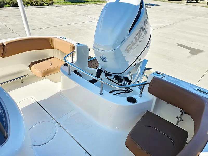 Slide: The Image of 2025 Pioneer 222 Sportfish boat with Suzuki outboard motor and brown seating. - 13