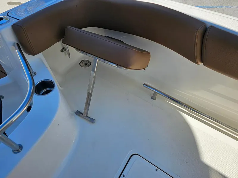 Slide: The Image of Interior of 2025 Pioneer 222 Sportfish boat with brown seating and stainless steel fixtures. - 14