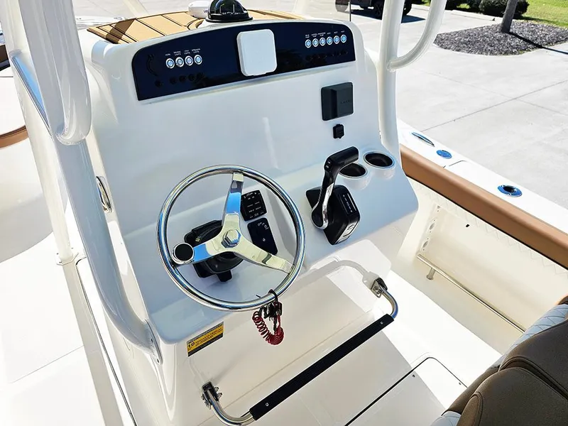 Slide: The Image of 2025 Pioneer 222 Sportfish boat console with steering wheel and controls. - 18