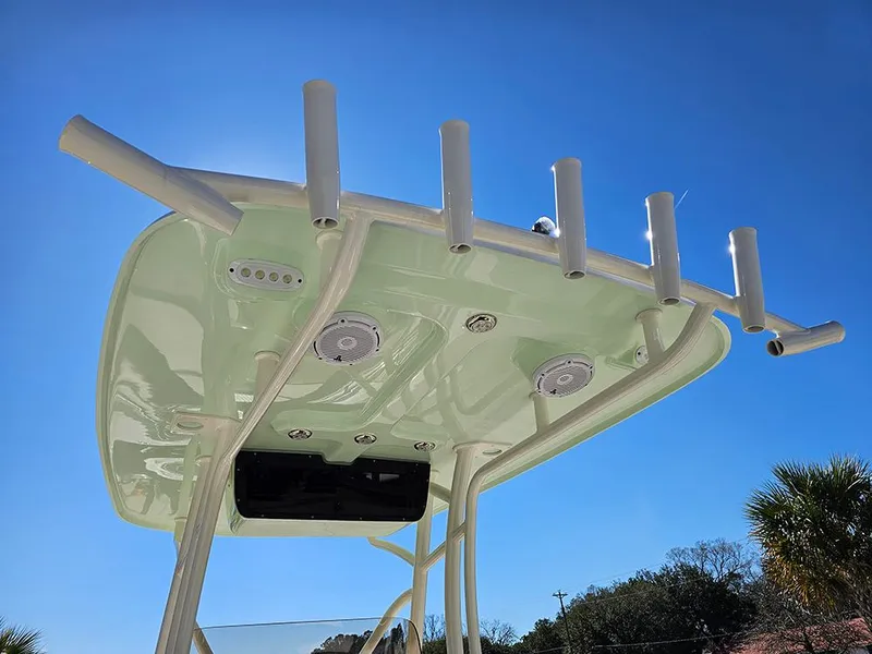 Slide: The Image of 2025 Pioneer 222 Sportfish boat top with rod holders against clear blue sky. - 19