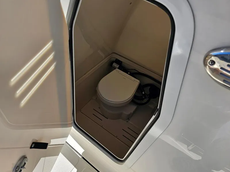 Slide: The Image of Compact marine toilet inside 2025 Pioneer 222 Sportfish boat. - 21