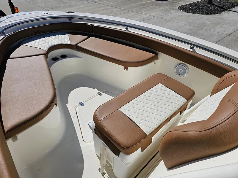 Slide: The Image of 2025 Pioneer 222 Sportfish boat interior with brown and white cushioned seating. - 22