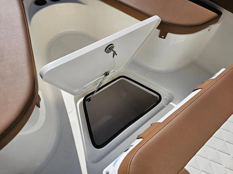 Slide: The Image of 2025 Pioneer 222 Sportfish boat interior with open storage compartment. - 23