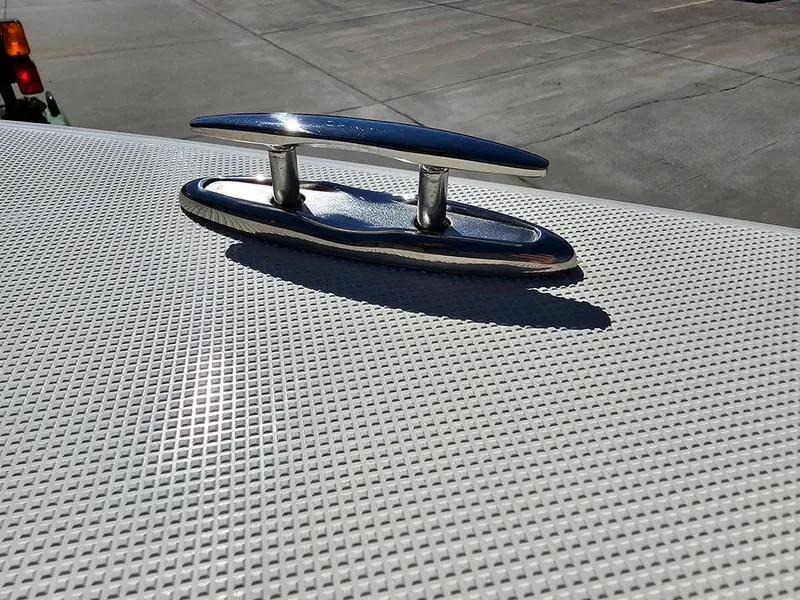 Slide: The Image of Chrome cleat on Pioneer 222 Sportfish 2025 boat deck, textured surface. - 28