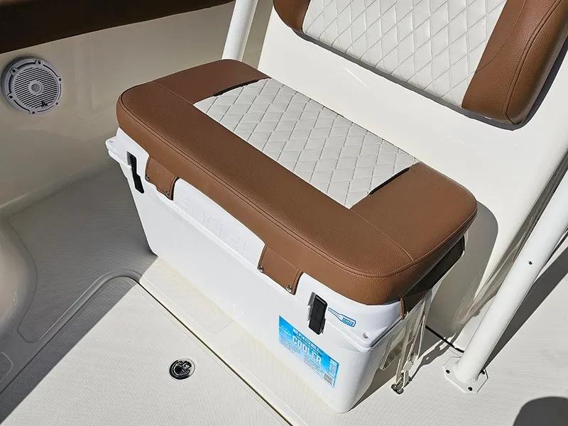 Slide: The Image of Pioneer 222 Sportfish 2025 boat seat with brown and white cushioned cooler. - 31