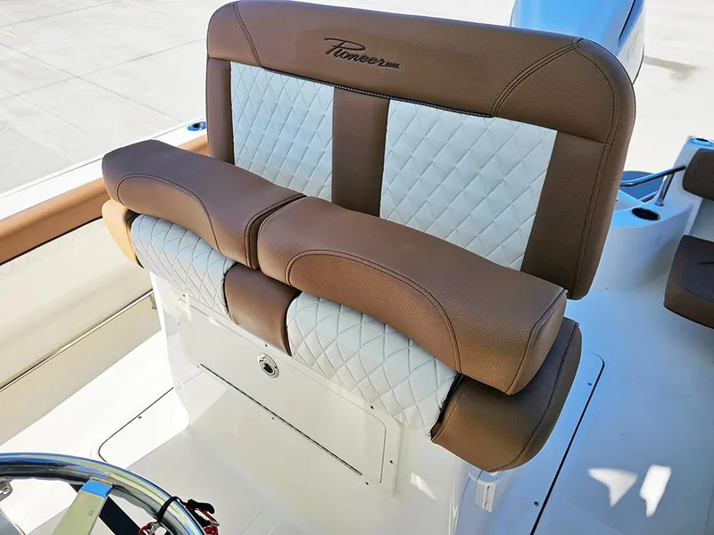 Slide: The Image of Luxury seating on 2025 Pioneer 222 Sportfish boat with brown and white upholstery. - 33